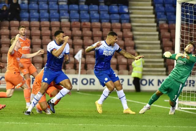 Curtis Tilt heads home Latics' late winner against Blackpool