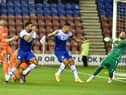 Curtis Tilt heads home Latics' late winner against Blackpool