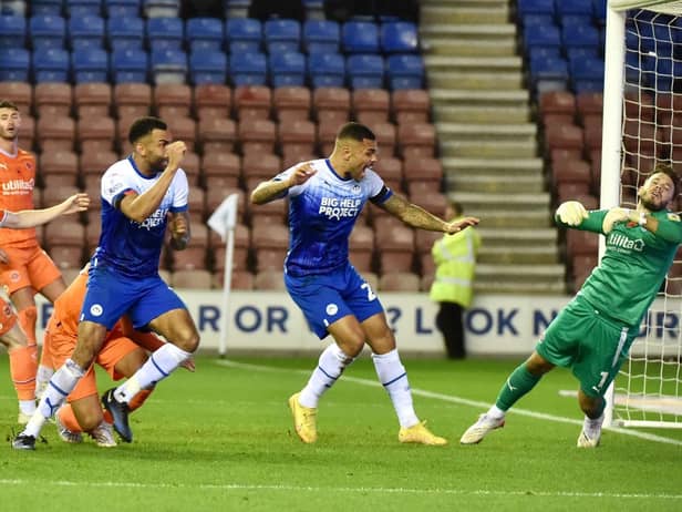 Curtis Tilt heads home Latics' late winner against Blackpool