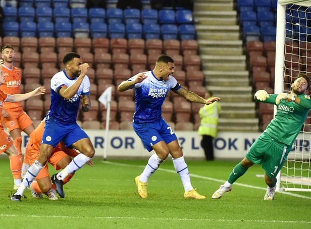 Curtis Tilt heads home Latics' late winner against Blackpool