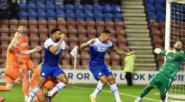 Curtis Tilt heads home Latics' late winner against Blackpool