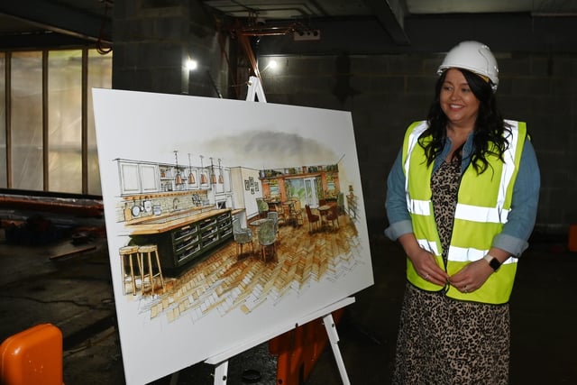 Regional manager Stacey Astin looks at the designs in the new building.