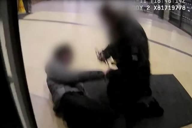 Police apply the cuffs to the teenager at Wigan bus station