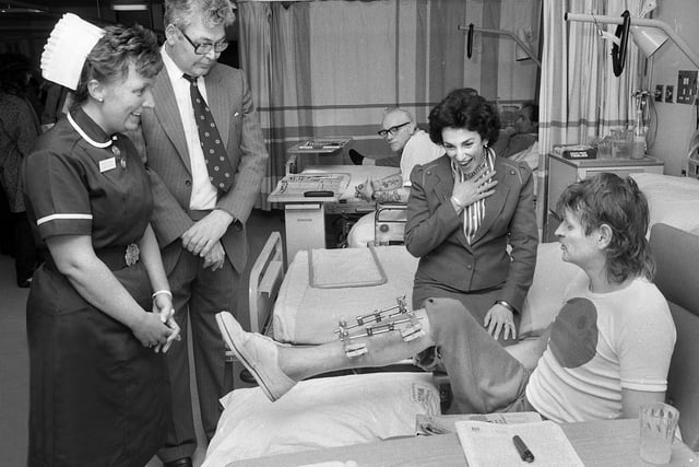 Junior Health Minister Edwina Currie is aghast at the metal brace on patient Peter Noble's leg as she tours a ward at Wigan Infirmary after officially opening the Acute Unit on Wednesday 1st of April 1987.