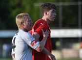 Chris Sze jostles with Latics old boy David Perkins