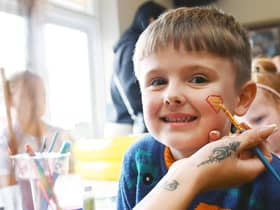 Isaac, five, gets his face painted.