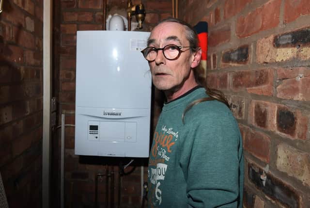 Mr Dickins pictured with a new boiler he did not need and hasn't eliminated water pressure problems.