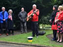Musician Lawrence Hoy performs at the 10th annual Workers' Memorial Day, with a ceremony around the memorial tree and plaque in Mesnes Park, Wigan.