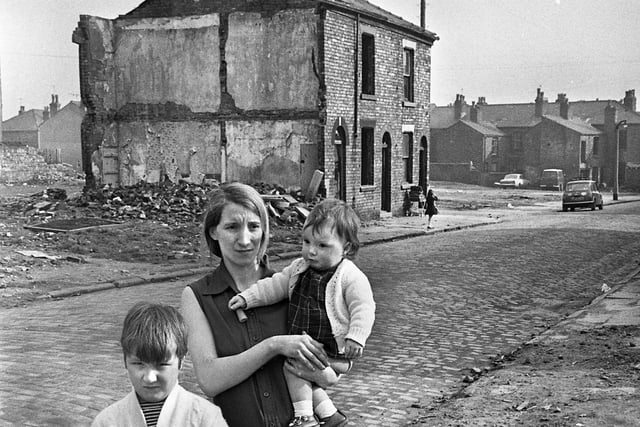 Margaret Baines with two of her children outside their house in Cambridge Street, Scholes.  Theirs was the last house standing in the street during the slum clearances in March 1973 and had no water or toilet while awaiting re-housing.