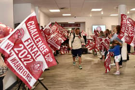 The players are led out by Thomas Leuluai