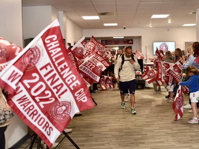 The players are led out by Thomas Leuluai
