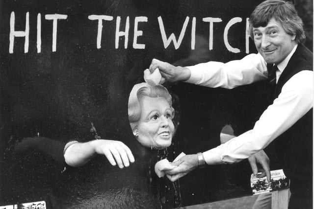 MP Roger Stott puts the squeeze on a Maggie Thatcher effigy during the May Day show at Haigh Hall in 1986.