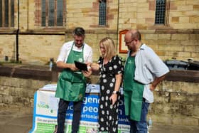 Project director Warren Done, former Leigh MP Jo Platt, and volunteer Paul Blinkhorn at the stall