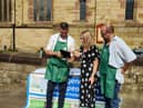 Project director Warren Done, former Leigh MP Jo Platt, and volunteer Paul Blinkhorn at the stall