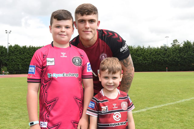 Brad O'Neill takes the time to have a photo with two young fans.
