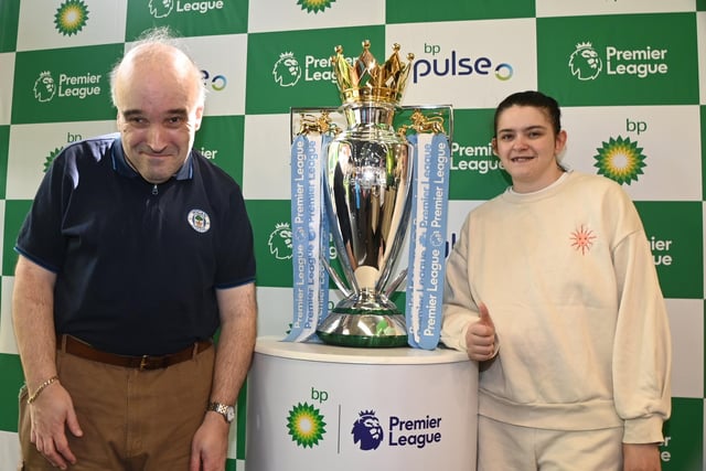 Members of One Vision pictured with the Premier League trophy