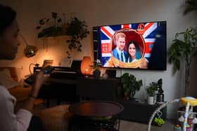 A woman watches an episode of the newly released Netflix docuseries "Harry and Meghan" about Britain's Prince Harry, Duke of Sussex, and Britain's Meghan, Duchess of Sussex, in London. Picture: Daniel Leal/AFP via Getty Images