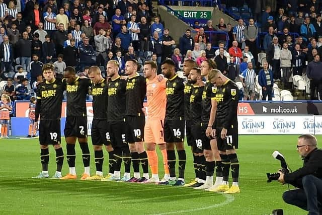 The Latics players pay their respects to Her Majesty The Queen at Huddersfield