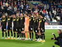 The Latics players pay their respects to Her Majesty The Queen at Huddersfield