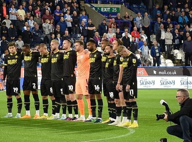 The Latics players pay their respects to Her Majesty The Queen at Huddersfield