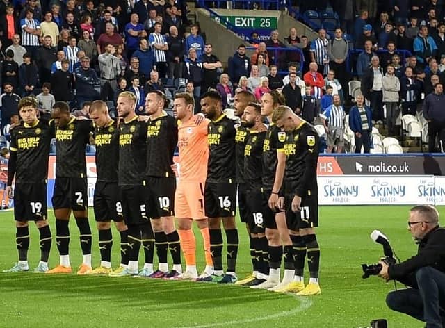 The Latics players pay their respects to Her Majesty The Queen at Huddersfield