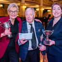 Band manager Norma Tinsley (left) accepting the award from competition adjudicators Alan Widdop and Stephanie Binns