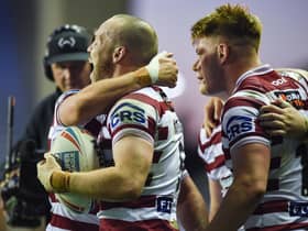 Liam Marshall scored a hat-trick as Wigan Warriors beat Warrington Wolves