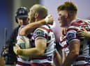 Liam Marshall scored a hat-trick as Wigan Warriors beat Warrington Wolves
