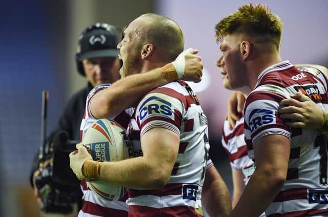 Liam Marshall scored a hat-trick as Wigan Warriors beat Warrington Wolves