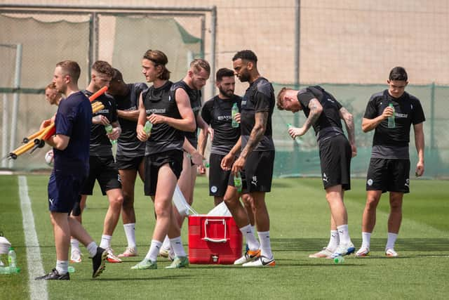 The Latics players grab a drink during their warm-weather camp in Dubai