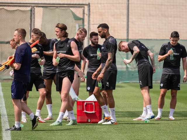 The Latics players grab a drink during their warm-weather camp in Dubai