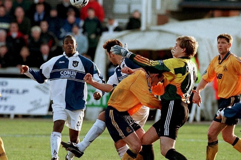 Roy Carroll comes for the ball as a future Latic looks on...