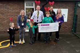 Landgate staff and pupils present their cheque to Wigan and Leigh Hospice