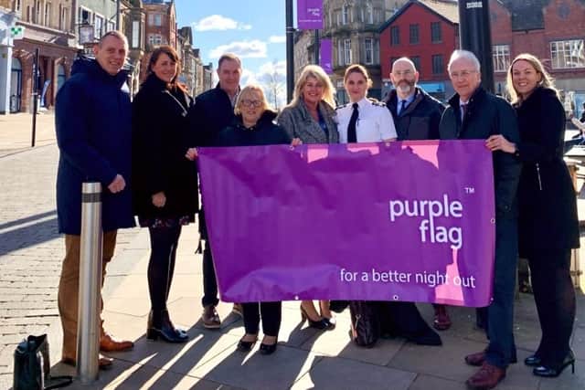 The Leader of Wigan Council, Coun David Molyneux MBE, Chief Executive of Wigan Council Alison McKenzie-Folan, GMP Wigan Chief Supt Emily Higham, and partners celebrate Purple Flag status
