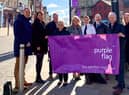 The Leader of Wigan Council, Coun David Molyneux MBE, Chief Executive of Wigan Council Alison McKenzie-Folan, GMP Wigan Chief Supt Emily Higham, and partners celebrate Purple Flag status