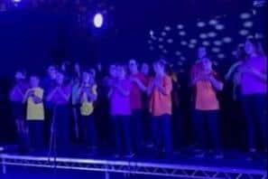 Pupils on stage from the Dean Trust at the Wigan youth Songfest event.
