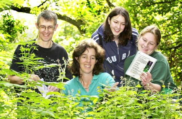 Collecting seeds in Borsdane Wood, Hindley, on Saturday 13th of July 2002 are John Loder, Bolton Conservation Volunteers, Annie Surtees, warden at Blackleach Country Park, Felicity Paris, Community Support Officer for Red Rose Forest and Sarah Sadler, Wigan Council countryside ranger. Some of the seeds found were bluebell, wild garlic and red campion and were to be scattered around Wigan borough in areas lacking colour.