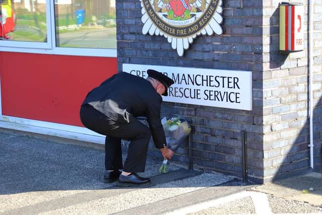Station Manager Chris Evans lays flowers at the front of the station.