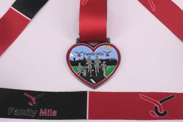 The medal for the family mile at the Wigan 10k 2024