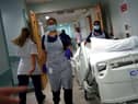 Medical staff transfer a patient along a corridor at the Royal Blackburn Teaching Hospital (Photo: HANNAH MCKAY/POOL/AFP via Getty Images)