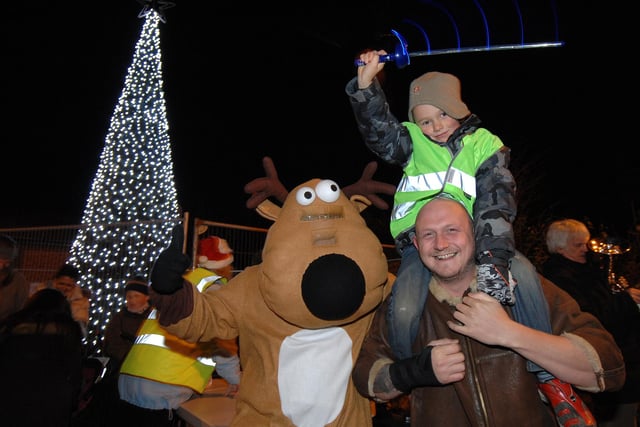 Golborne Christmas lights switch-on:  David Gosling and son William, six, with Golborne Asda's reindeer