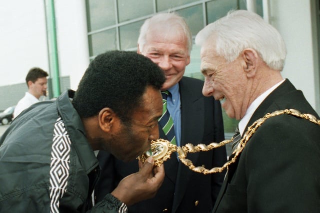 Pele kisses the chain of Wigan Mayor Coun Bernard Coyle, watched by an amused Dave Whelan