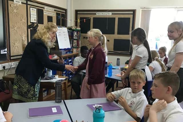 Students receiving their badges