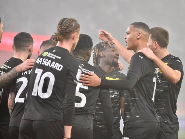 The Latics players celebrate Baba Adeeko's winning goal at Rotherham