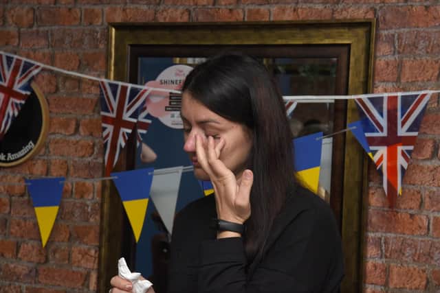 Photo Neil Cross;  Ukraine refugee and salon employee, Inna Hashynskya, is overcome with emotion