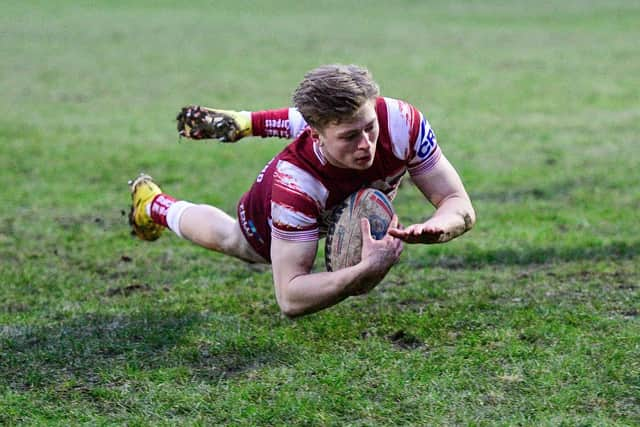 Logan Astley of Wigan Warriors scores against Whitehaven at Recreation Ground Stadium during pre-season