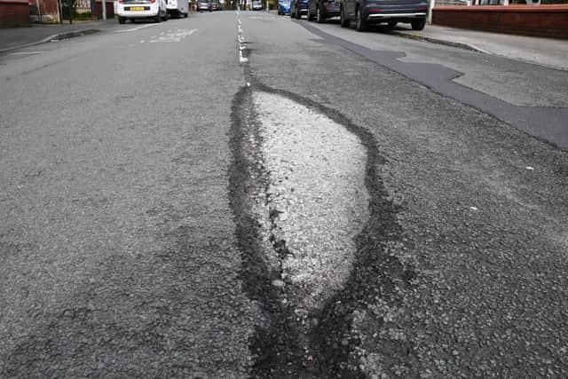 The disintegrating road surface on  Prescott Lane, Kitt Green