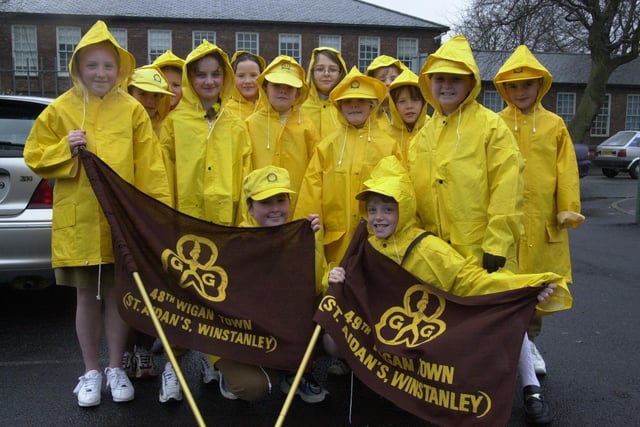 2001 - Braving the rain at St Georges Day parade are 48th Wigan Town St Aidan's Winstanley Brownies.