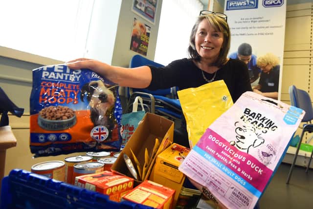 Branch manager Eleanor Mansell with some of the donations which will be sent to food banks for pet owners, Feature on the work at RSPCA Wigan, Leigh and District, York Street, Wigan.
