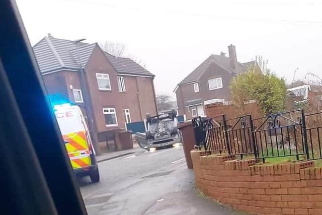 The car on its roof in Lamberhead Road